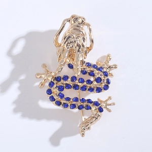 Macro detail of golden dragon brooch showing intricate blue rhinestone inlay and craftsmanship