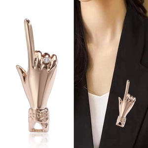 Hip-hop gesture pin brooch in rose gold alloy with crystal accent on black suit lapel