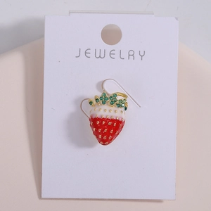 Detailed macro view of strawberry earrings with red gradient enamel and green gemstones