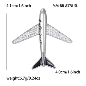 Detailed macro view of silver airplane brooch with zircon wings and Love You Forever engraving