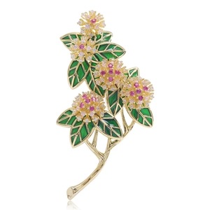 Macro detail of floral brooch with pink zircon petals and green enamel leaves