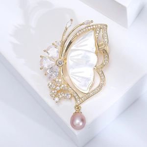 Elegant butterfly brooch with shell inlay, sparkling zircons and pink pearl pendant