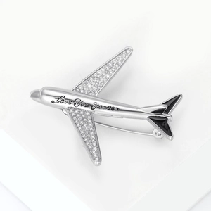 Detailed macro view of silver airplane brooch with Love You Forever engraving and zircon