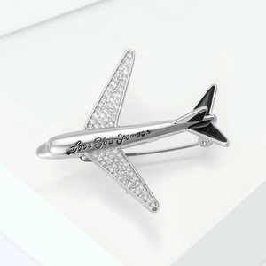 Detail of silver airplane brooch with pave crystals and Love You Forever engraving
