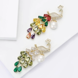 Elegant peacock brooch with colorful zircon and pearl on minimalist white pedestal