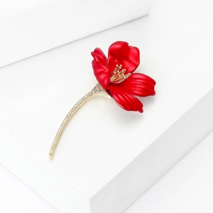 Exquisite red hibiscus brooch with zircon and gold stem on white geometric background