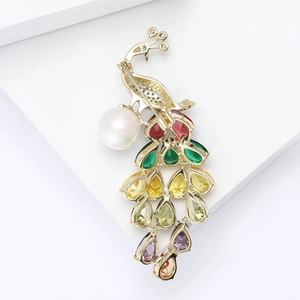 Elegant gold peacock brooch with colorful teardrop crystals and a round white pearl