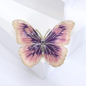Detailed macro view of enamel butterfly brooch featuring purple gradient wings and gold trim