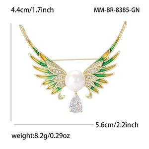 Luxury angel wing brooch with green enamel, zircons and pearls in gold finish