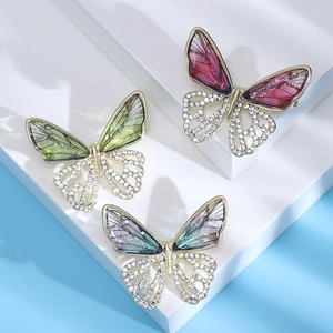 Three elegant hollow butterfly brooches with colorful wings and sparkling rhinestones