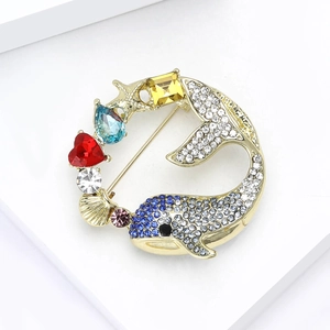 Exquisite gold whale brooch with rhinestones, starfish and shell on a display stand