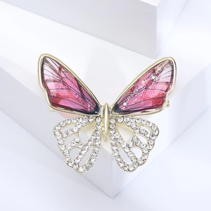 Detail of hollow butterfly brooch with pink translucent wings and pavé white crystals