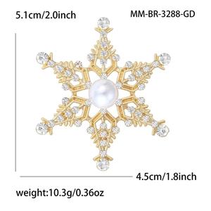 Broche flocon de neige dorée avec strass scintillants et une perle blanche centrale