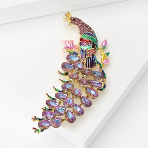 Macro detail of peacock brooch showing purple crystals and colorful enamel textures