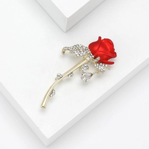 Fashion alloy red rose brooch with rhinestones and drop pendant on white display stand