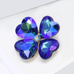 Macro shot of high-quality clover brooch with blue and purple gradient crystal stones