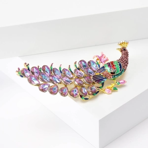 Detailed close-up of peacock brooch featuring purple rhinestones and colorful enamel