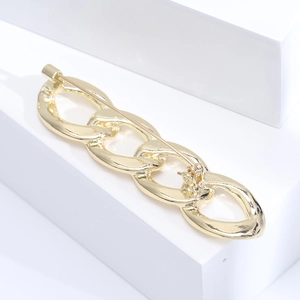 Detailed view of the gold chain link brooch with a secure rotating safety clasp