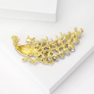 Detail view of the peacock brooch back showing sturdy pin and secure rotating clasp