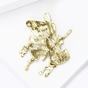 Detail of music brooch back showing secure pin clasp and brushed metal texture finish