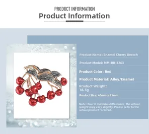 Detail view of red cherry enamel brooch with green leaves and alloy material specs