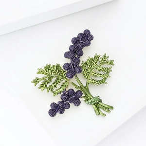 Detailed macro view of a purple lavender plant brooch with green enamel leaves and rhinestones