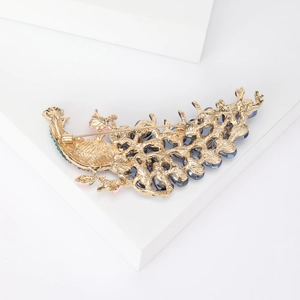 Exquisite peacock brooch in gold finish with blue rhinestones and pink enamel details