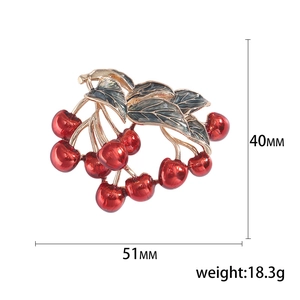 Vibrant cherry brooch with red enamel fruits and golden trim leaves, 51mm by 40mm