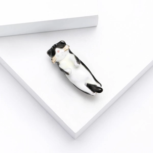 Cute black and white enamel cat brooch with gold whiskers on white geometric cubes