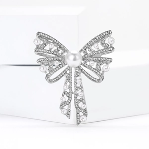 Elegant bow brooch with pearls and rhinestones on silver base for sweaters and suits