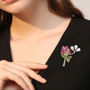 Elegant hydrangea brooch with pink enamel flowers and pearls on a black V-neck top