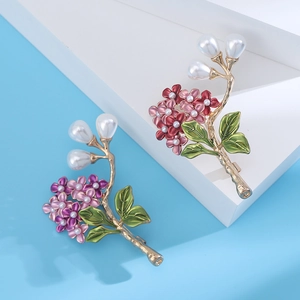 Detail of elegant hydrangea flower brooches with enamel petals and pear-shaped pearls