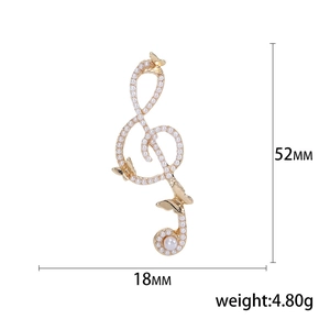 Elegant gold treble clef brooch with butterfly and pearls, size 52mm by 18mm