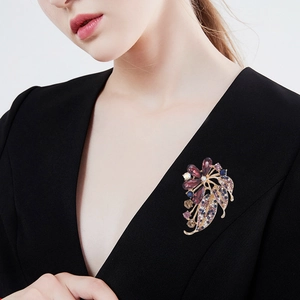 Elegant floral rhinestone brooch with colorful crystals on a black suit lapel