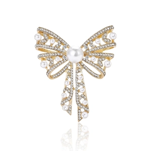 Elegant gold bow brooch with sparkling crystals and large white pearls for sweaters