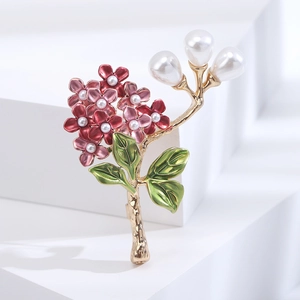 Macro view of hydrangea floral brooch featuring pink enamel flowers and pearl accents