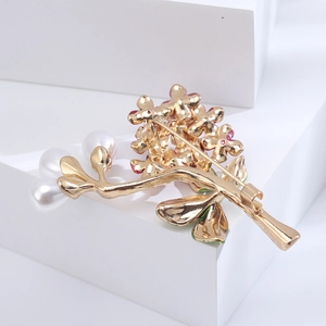 Macro shot showing the gold-plated back structure and safety pin of the hydrangea brooch
