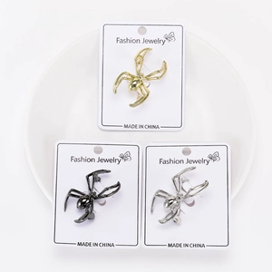 Detailed set of three spider brooches in gold, silver and black finish on cards