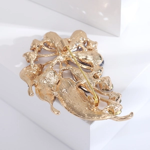 Macro shot of the gold brooch back with pin clasp and detailed metal texture