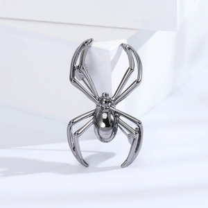 Macro shot of spider shaped metal brooch in polished gunmetal grey plating for men's suit
