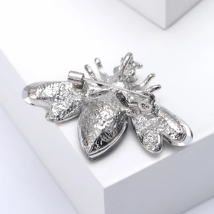 Detailed back view of silver bee brooch showing secure metal pin clasp mechanism
