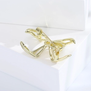 Golden gymnast dancer brooch pin for suits with polished alloy finish on white podium