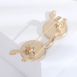 Detailed macro view of the gold alloy cartoon brooch back with a secure pin clasp