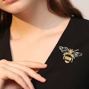 Creative alloy bee brooch with yellow enamel and gemstone on black blazer lapel