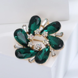 Elegant emerald crystal floral wreath brooch with a sparkling emerald green gemstone finish