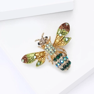 Détails d'une broche abeille vintage avec émail coloré et strass brillants sertis