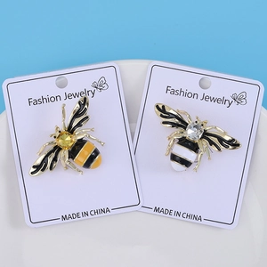 Detail view of bee brooches with enamel plating and crystal on fashion cards