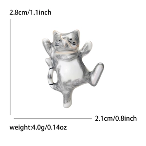 Detailed view of enamel dancing cat brooch with dimensions of 2.8cm height and 2.1cm width
