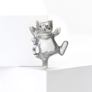 Cute dancing cat brooch with grey and white marble enamel finish on white display stand