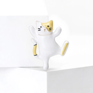 Cute dancing white cat brooch with yellow spots and enamel finish in a minimalist setting